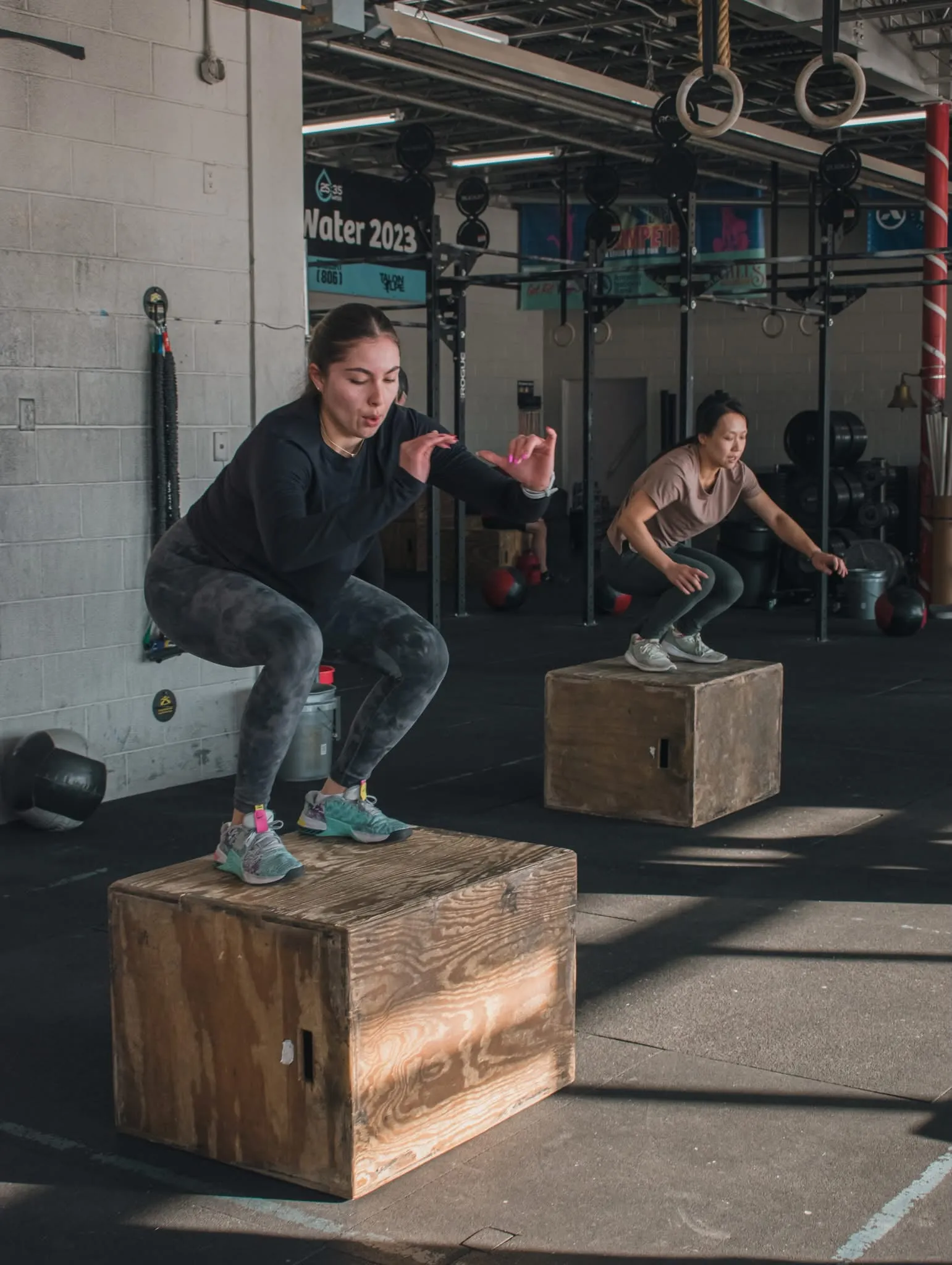 Members doing box jumps during a class at CrossFit 806