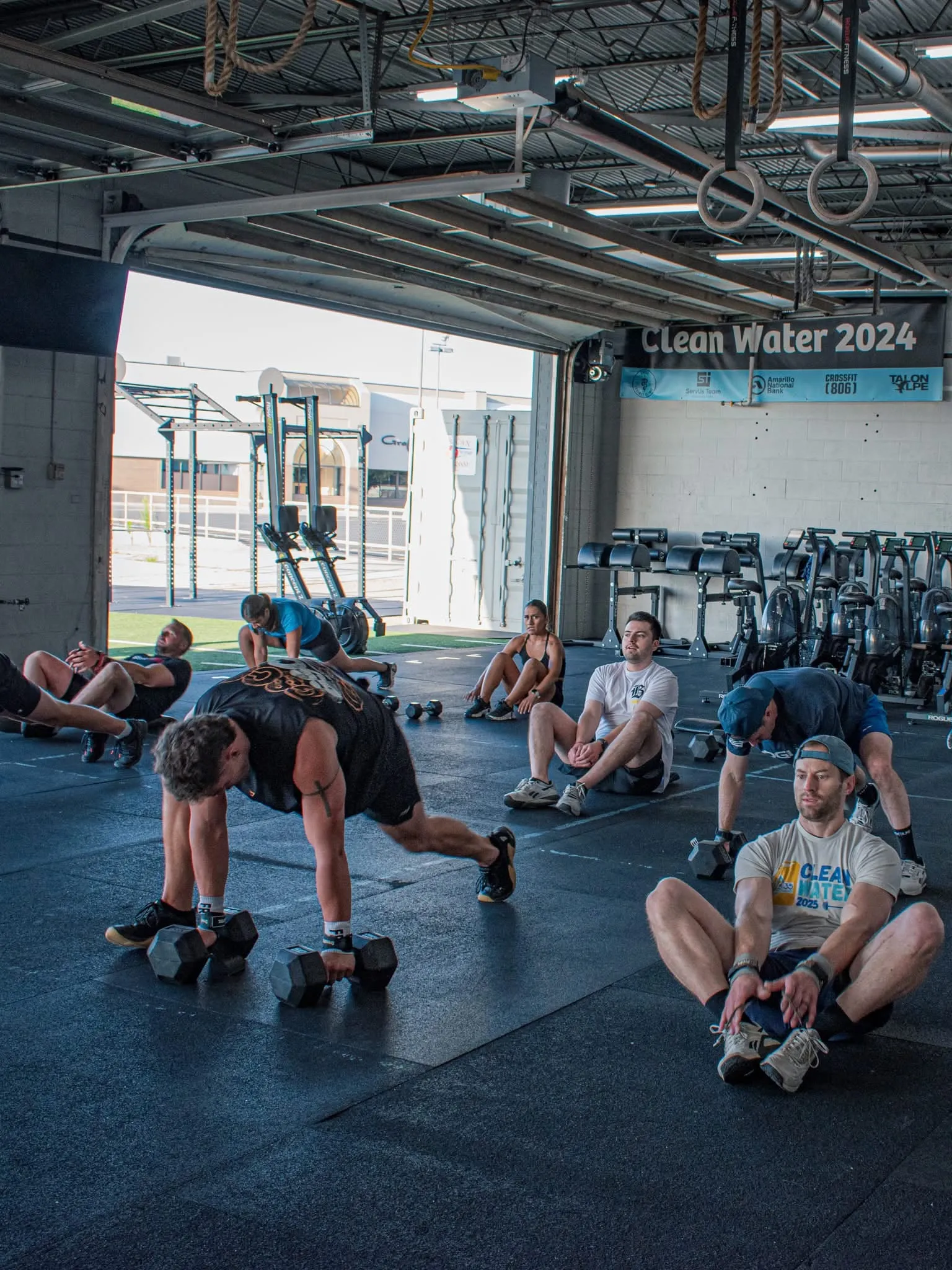A CrossFit 806 class working through a dumbbell workout on the gym floor in Amarillo, Texas